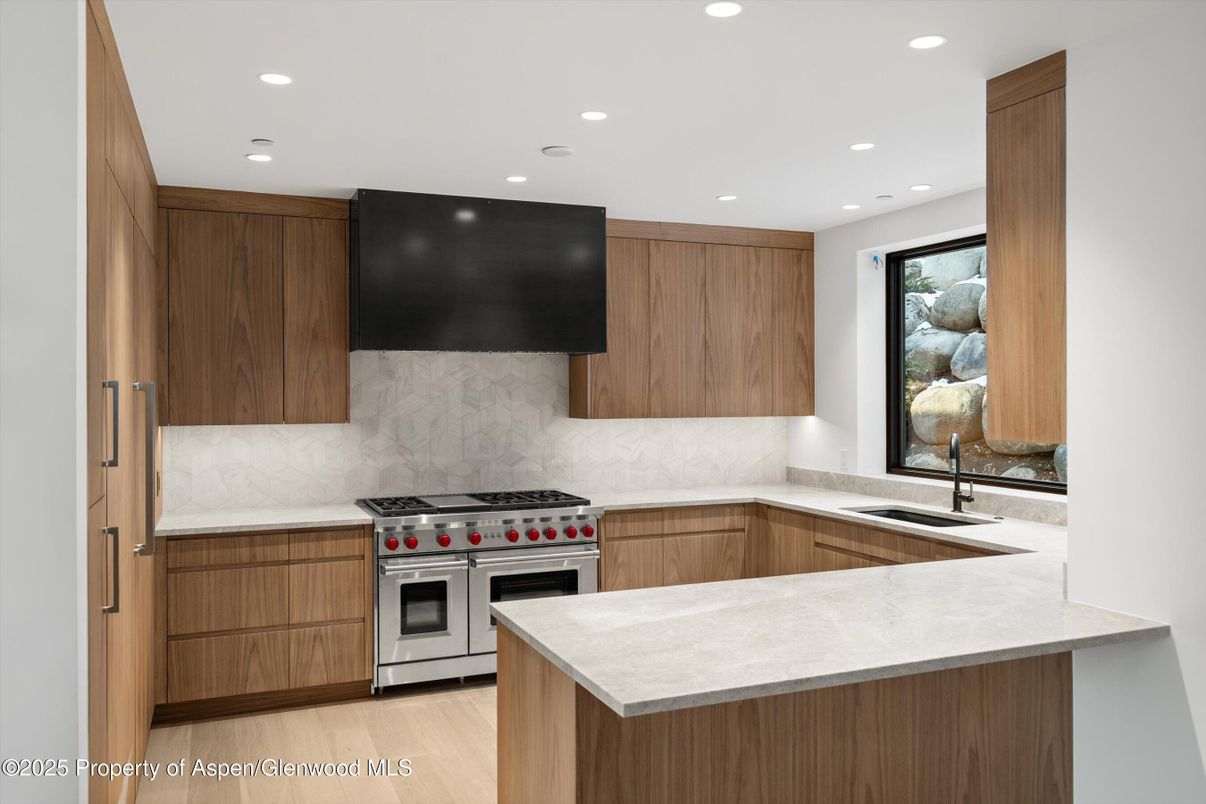 Interior, Kitchen, Marble Walls, Recessed Lighting, Stainless Steel Appliances, Wood Texture Flooring