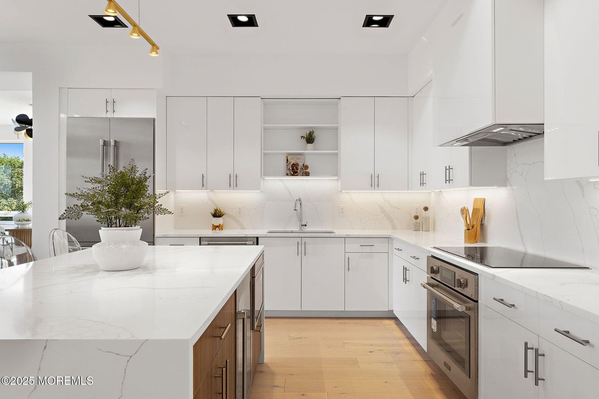 Interior, Kitchen, Marble Walls, Recessed Lighting, Stainless Steel Appliances, Wood Texture Flooring