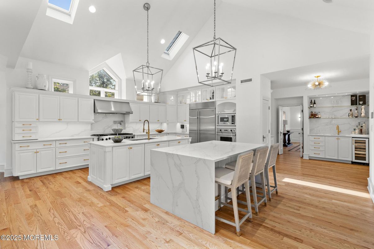 Interior, Kitchen, Marble Walls, Pendant Lights, Recessed Lighting, Stainless Steel Appliances, Wood Texture Flooring