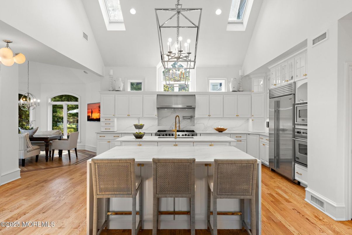 Chandelier, Dining room, Interior, Kitchen, Pendant Lights, Recessed Lighting, Stainless Steel Appliances, Wood Texture Flooring